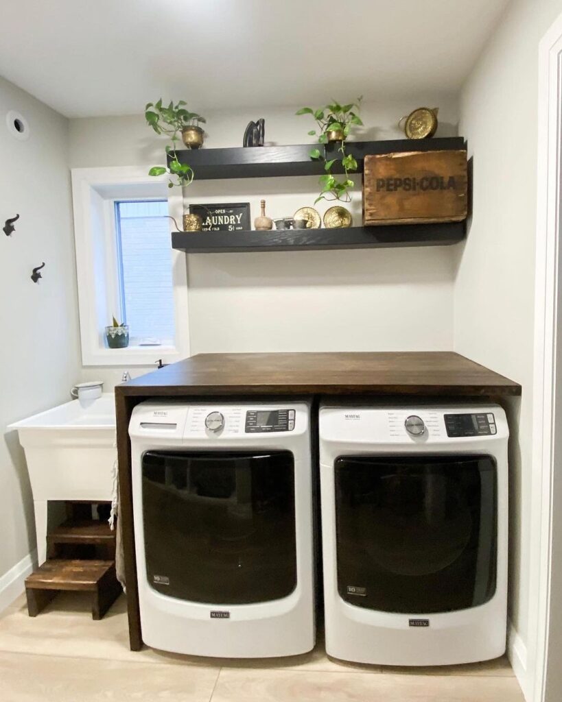 Laundry room with modern appliances rustic shelves and vintage accessories