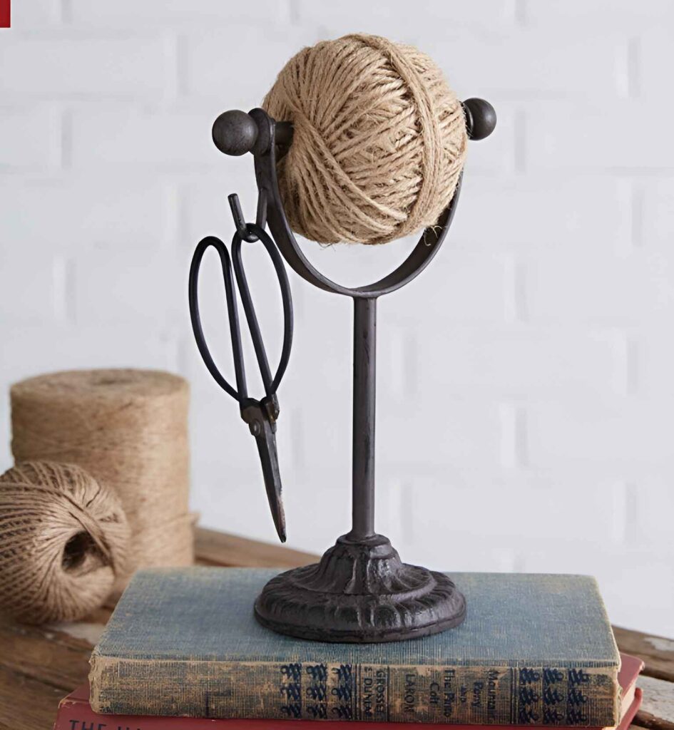 Iron twine holder with scissors on vintage books.