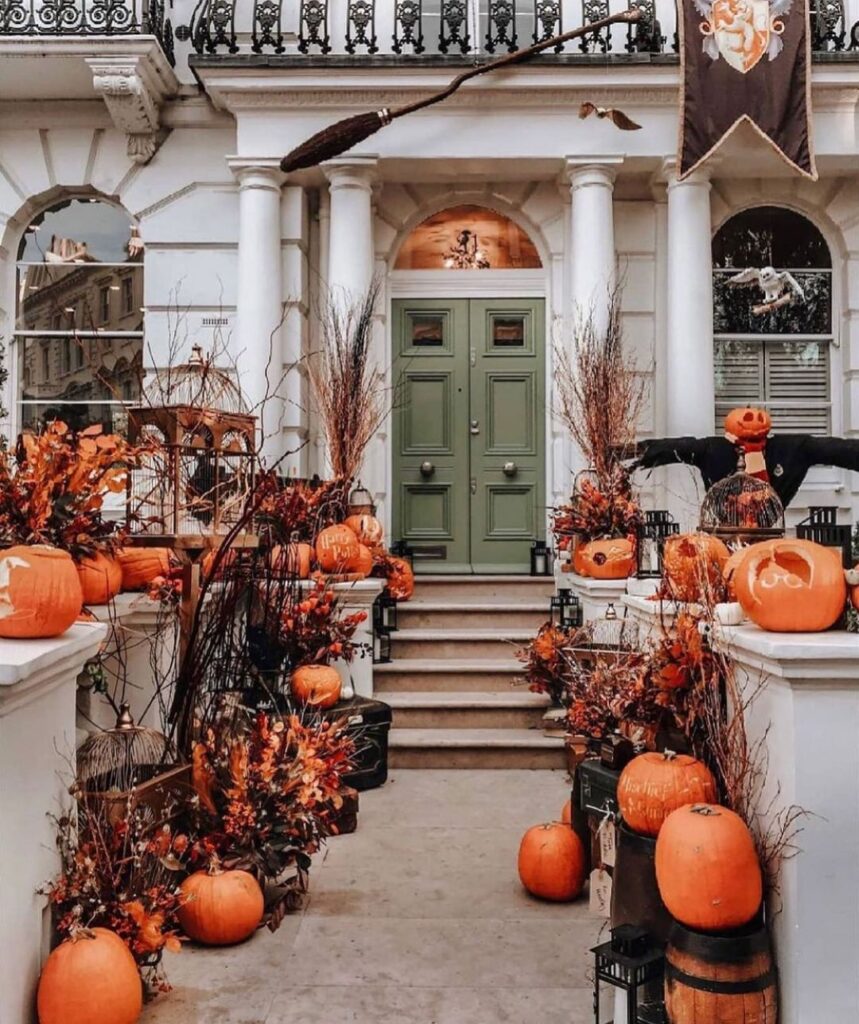 Townhouse entrance decorated with pumpkins and Halloween decor