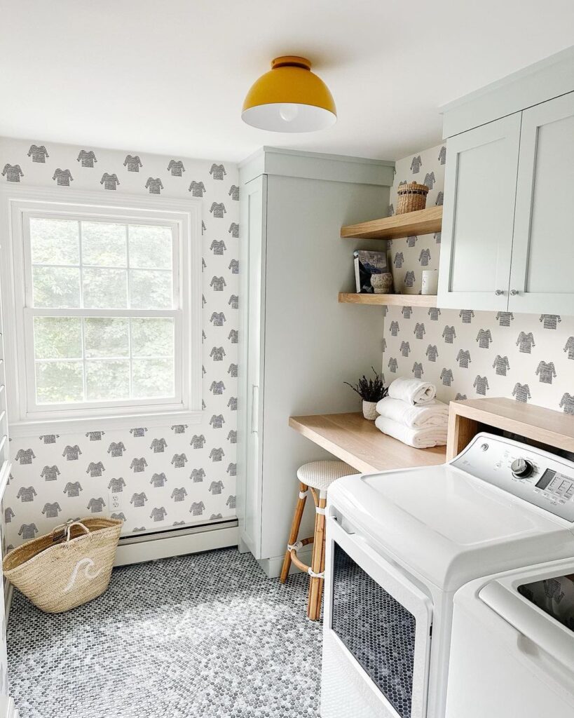 Bright laundry room with sweater-patterned wallpaper and yellow light