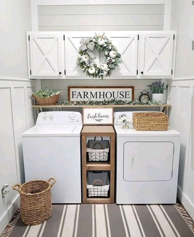 White farmhouse laundry room with decorative wreath and rustic accents.