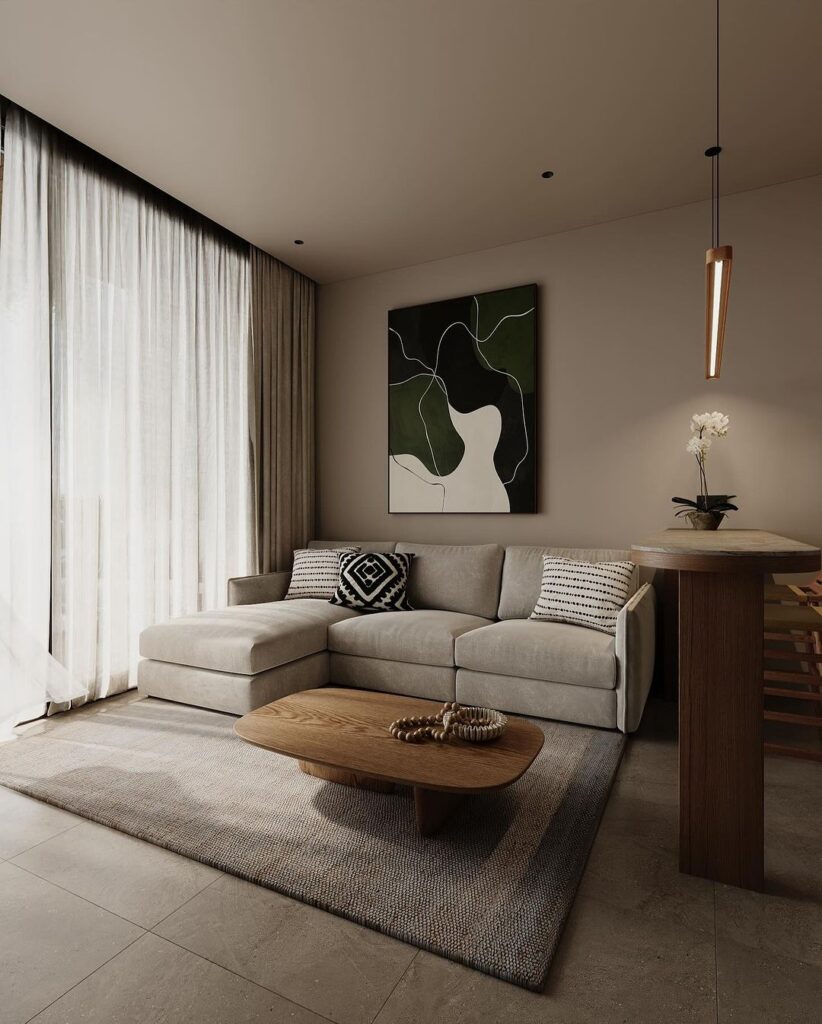 Minimalist living room with abstract art, sectional sofa, and wooden accents.