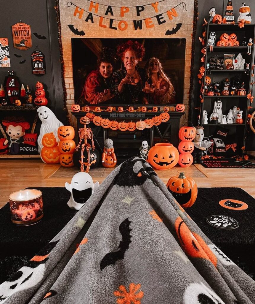 Witchy Halloween decor surrounding festive fireplace