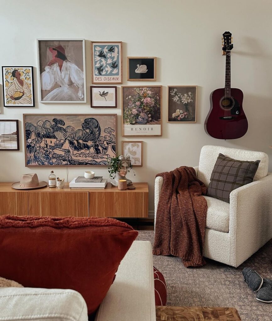 Cozy living room corner with art gallery wall and guitar.