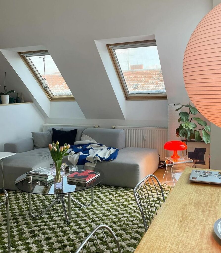 Attic living room with skylights and colorful accents.