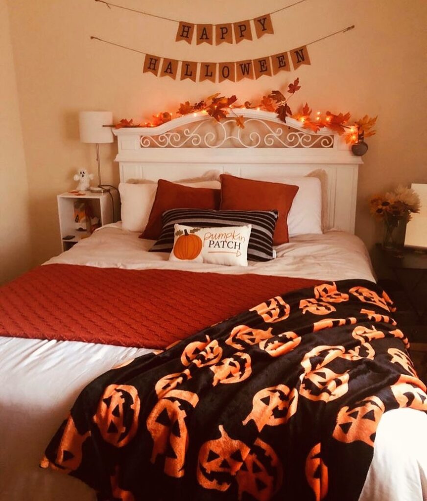 Halloween-themed bedroom with autumn decorations and pumpkin bedding