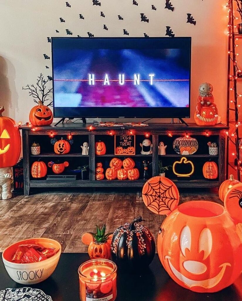 Halloween-decorated living room with TV and pumpkins