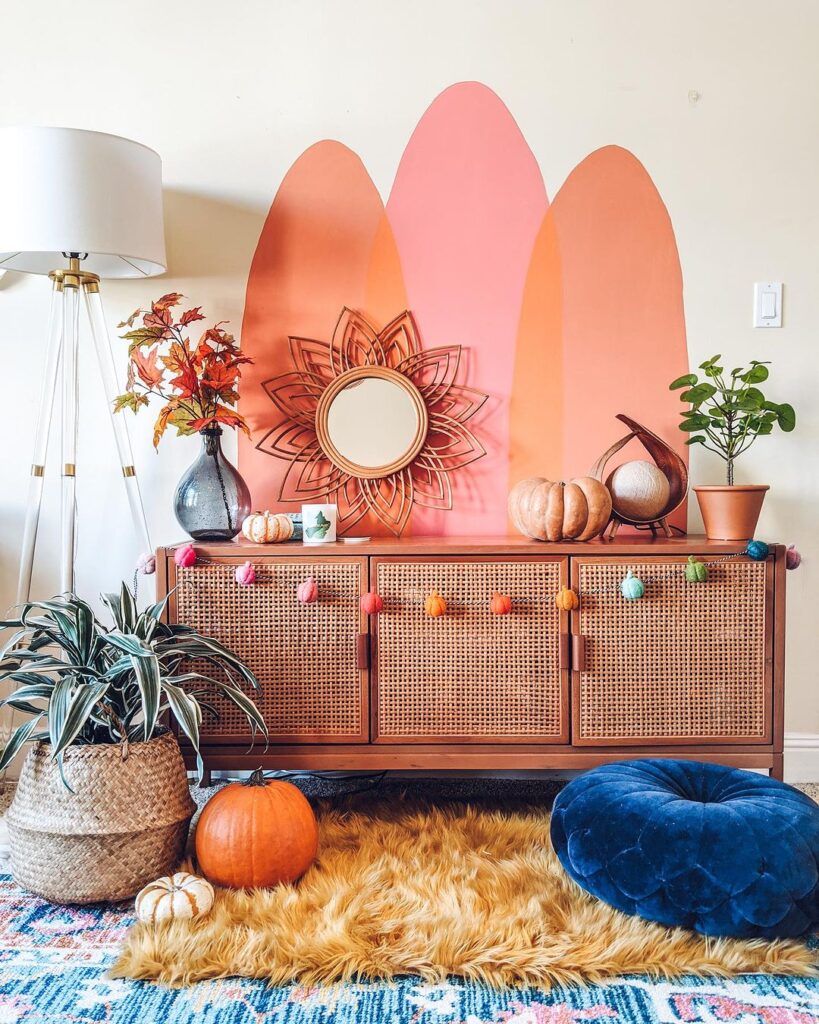 Boho-style room with autumn decor and pumpkins.