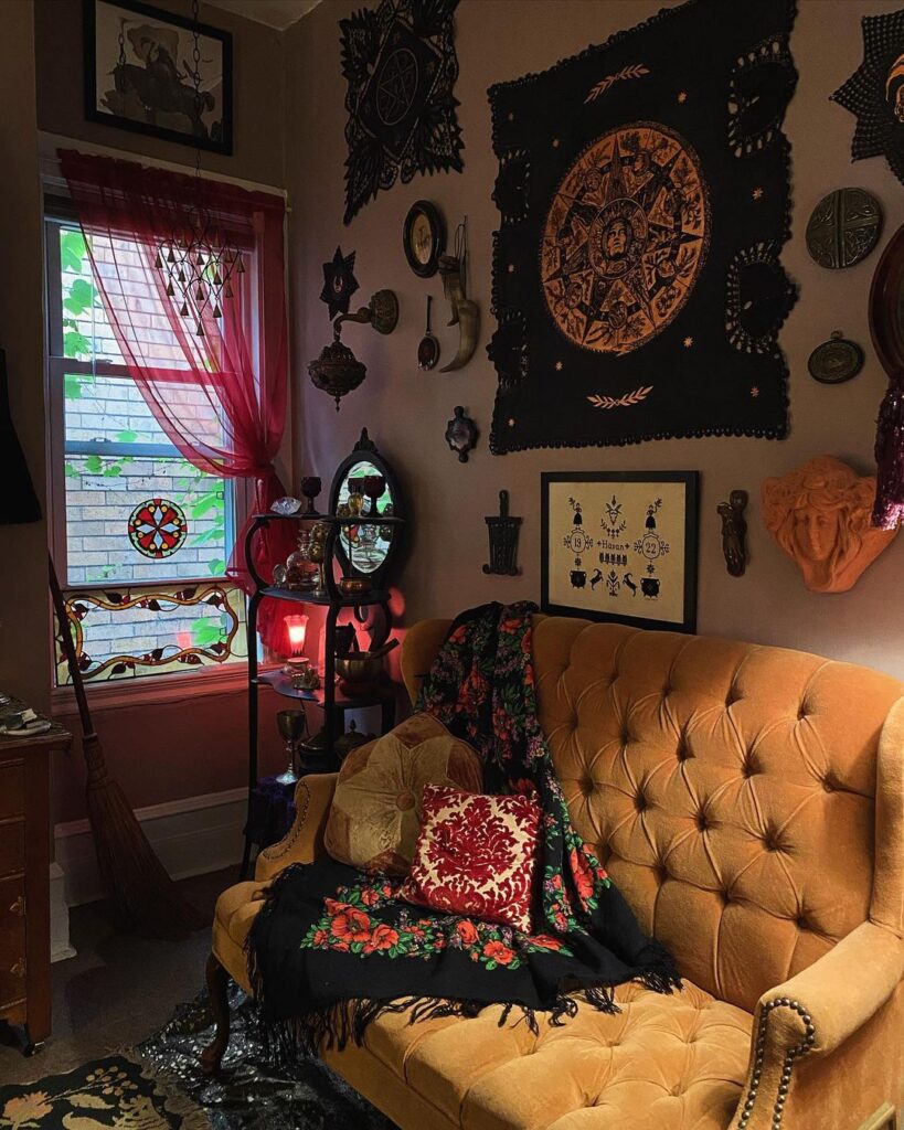 Witchy living room with zodiac tapestry and golden couch