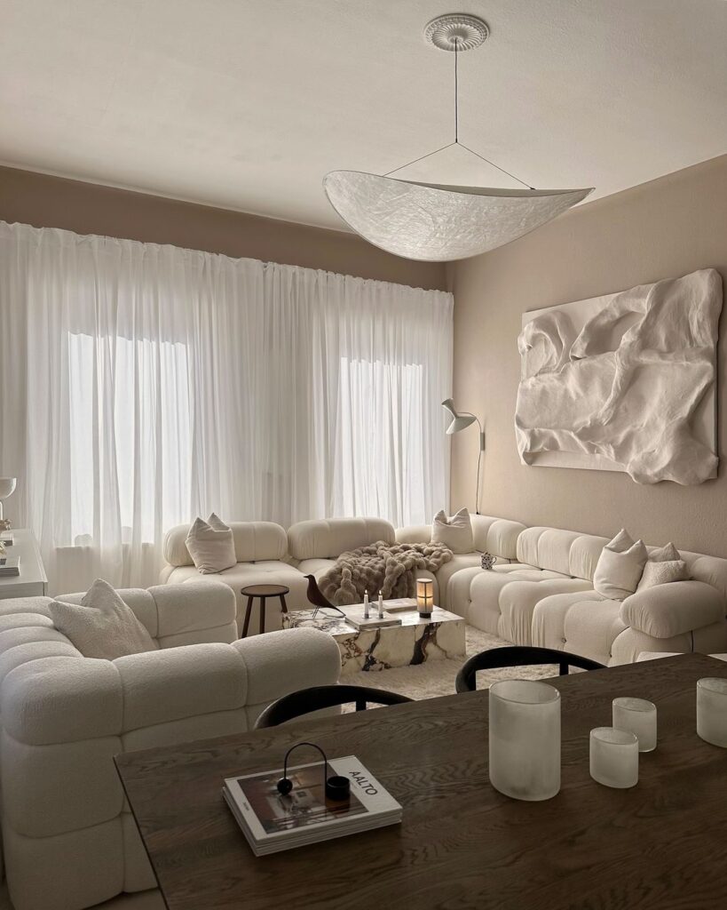 Minimalist white living room with cloud-like sofas