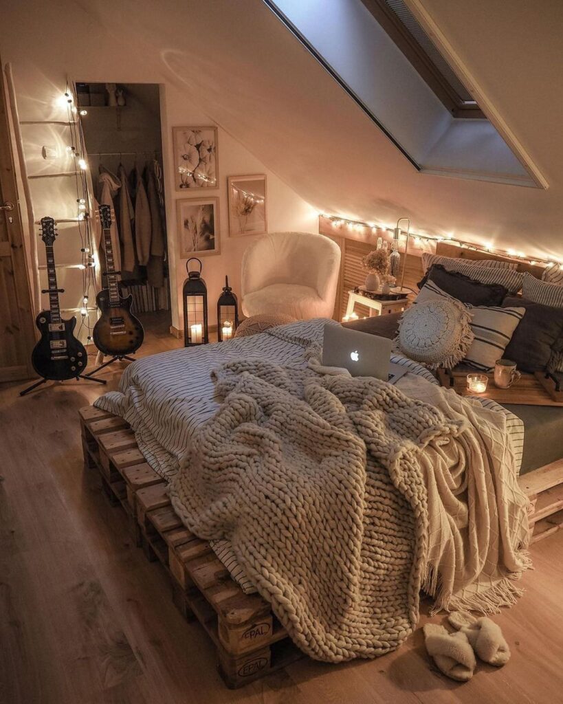 Attic bedroom with guitars pallet bed and fairy lights