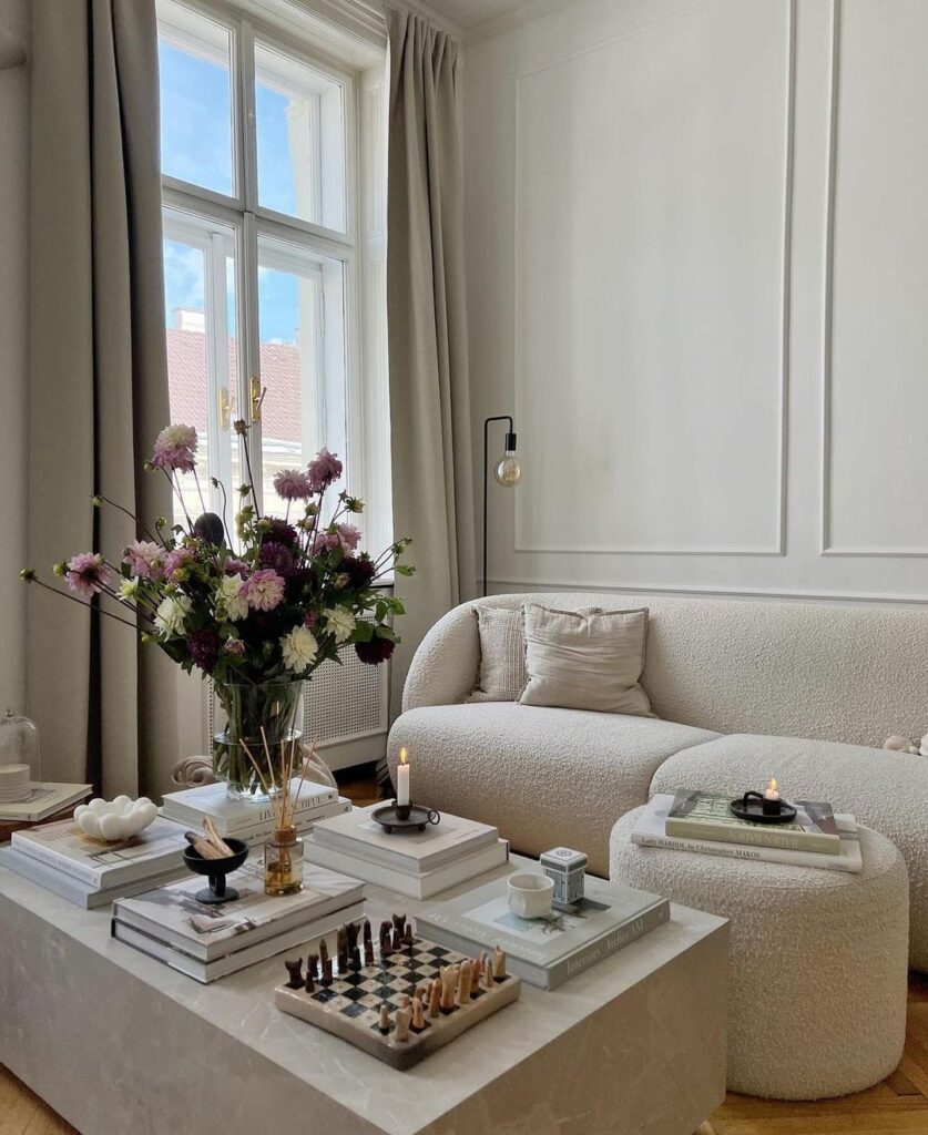 Bright living room corner with cozy sofa and floral arrangement