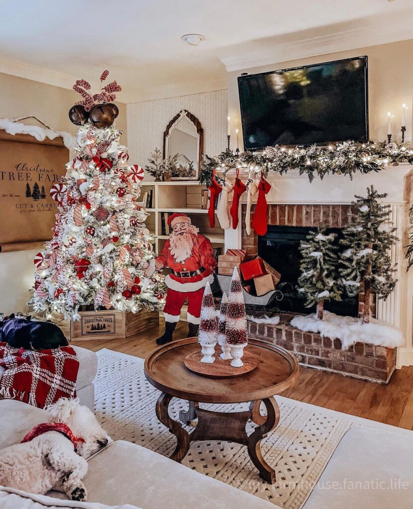 Christmas living room with candy cane tree, Santa figure, and sleeping dog.