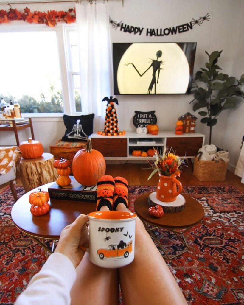 Halloween-decorated living room with pumpkins and spooky decor