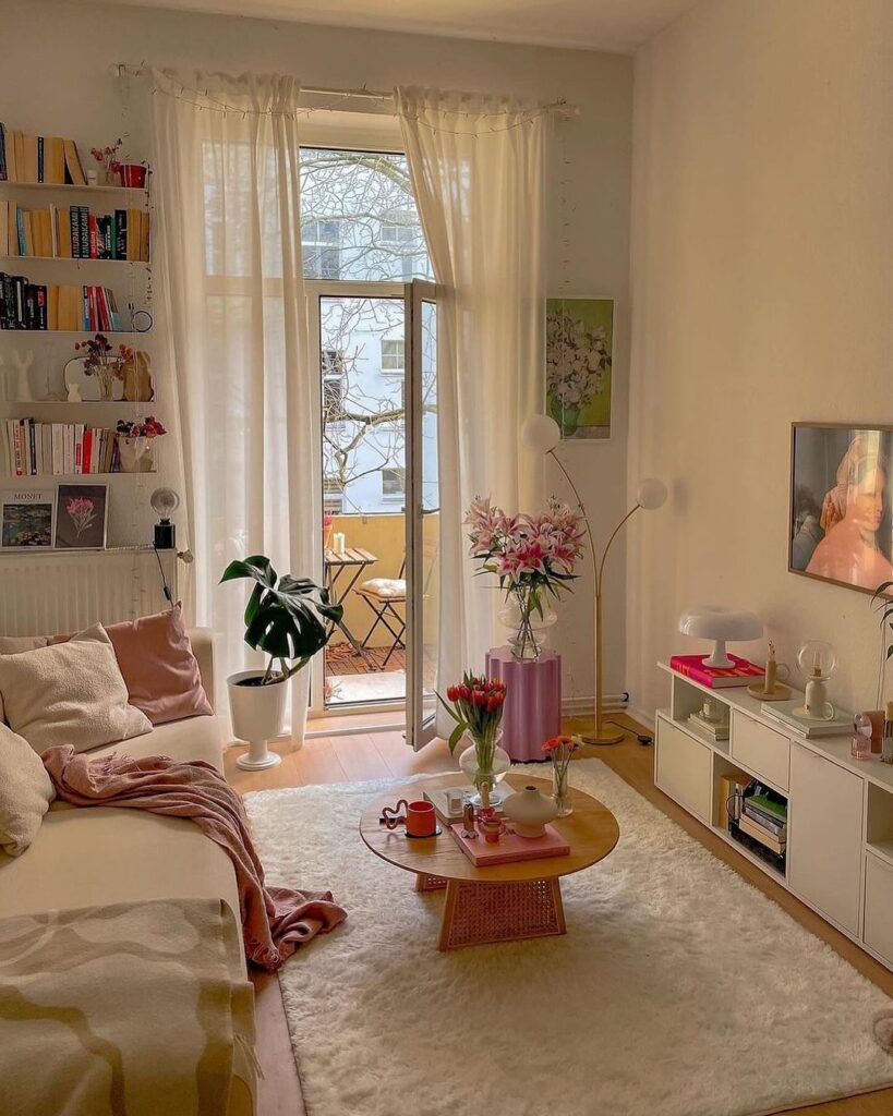 Bright living room with books flowers and balcony