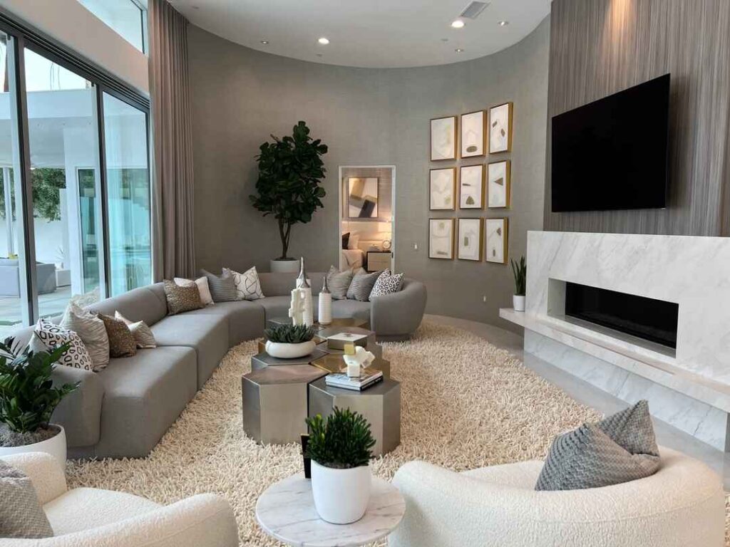 Cozy curved living room with grey sofa and modern decor.