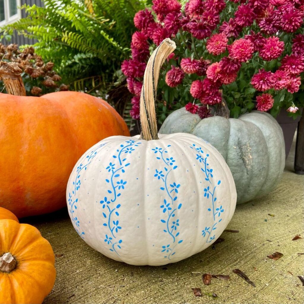 White pumpkin painted with blue floral vines