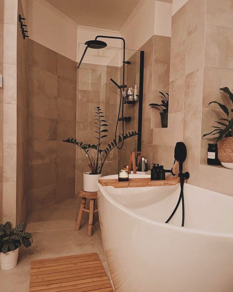 Modern bathroom with beige tiles black fixtures and plants