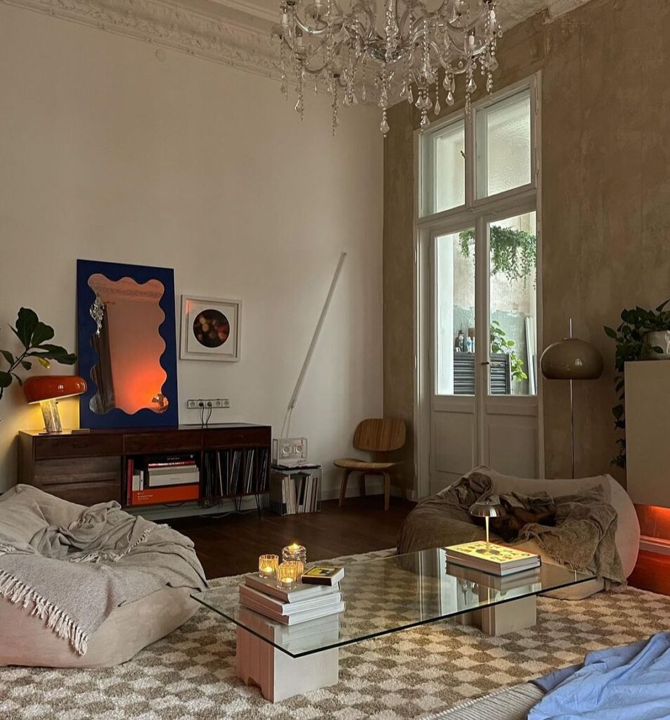 Cozy living room with chandelier modern art and floor cushions