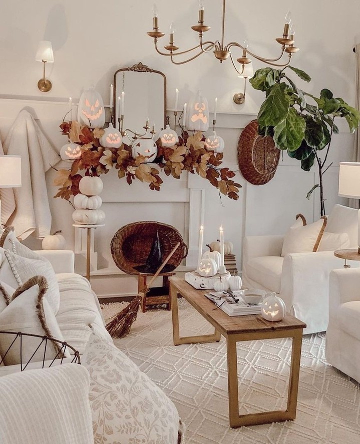 White living room with elegant Halloween decor and pumpkins.