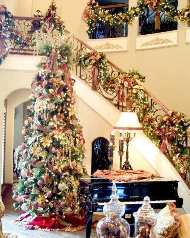 "Vintage Christmas tree beside grand piano staircase garlands"