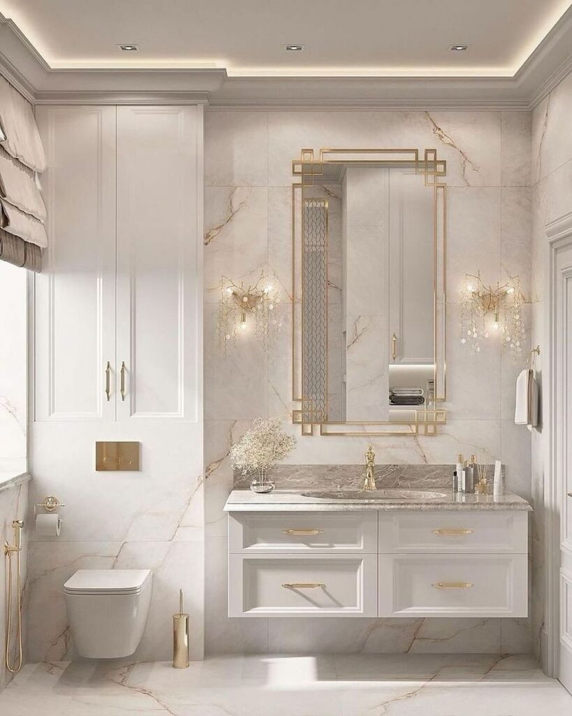 Luxurious white bathroom with marble surfaces, gold accents, and minimalist vanity.