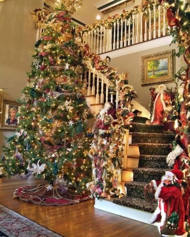 "Vintage Christmas tree and decorated staircase with Santa figure and gold accents"