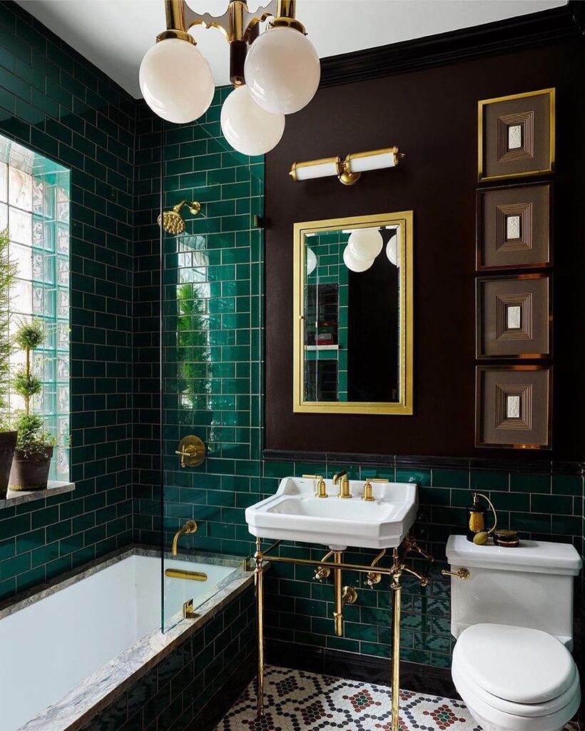 Emerald tiled bathroom with gold fixtures and vintage charm