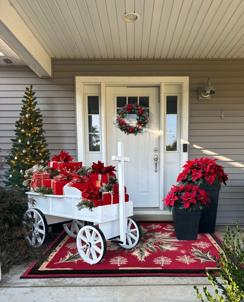 White wagon with red gifts and poinsettias on Christmas porch