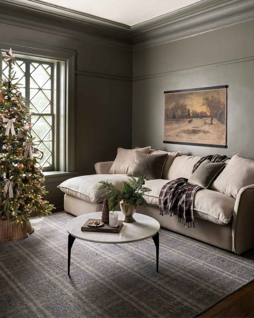 Mid-century living room with Christmas tree, beige sofa, and round coffee table.