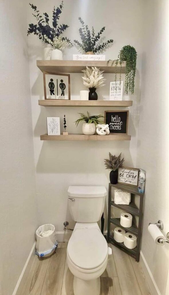 Floating shelves above toilet with decor