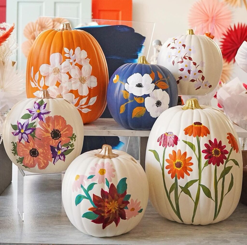 Pumpkins painted with colorful floral designs.
