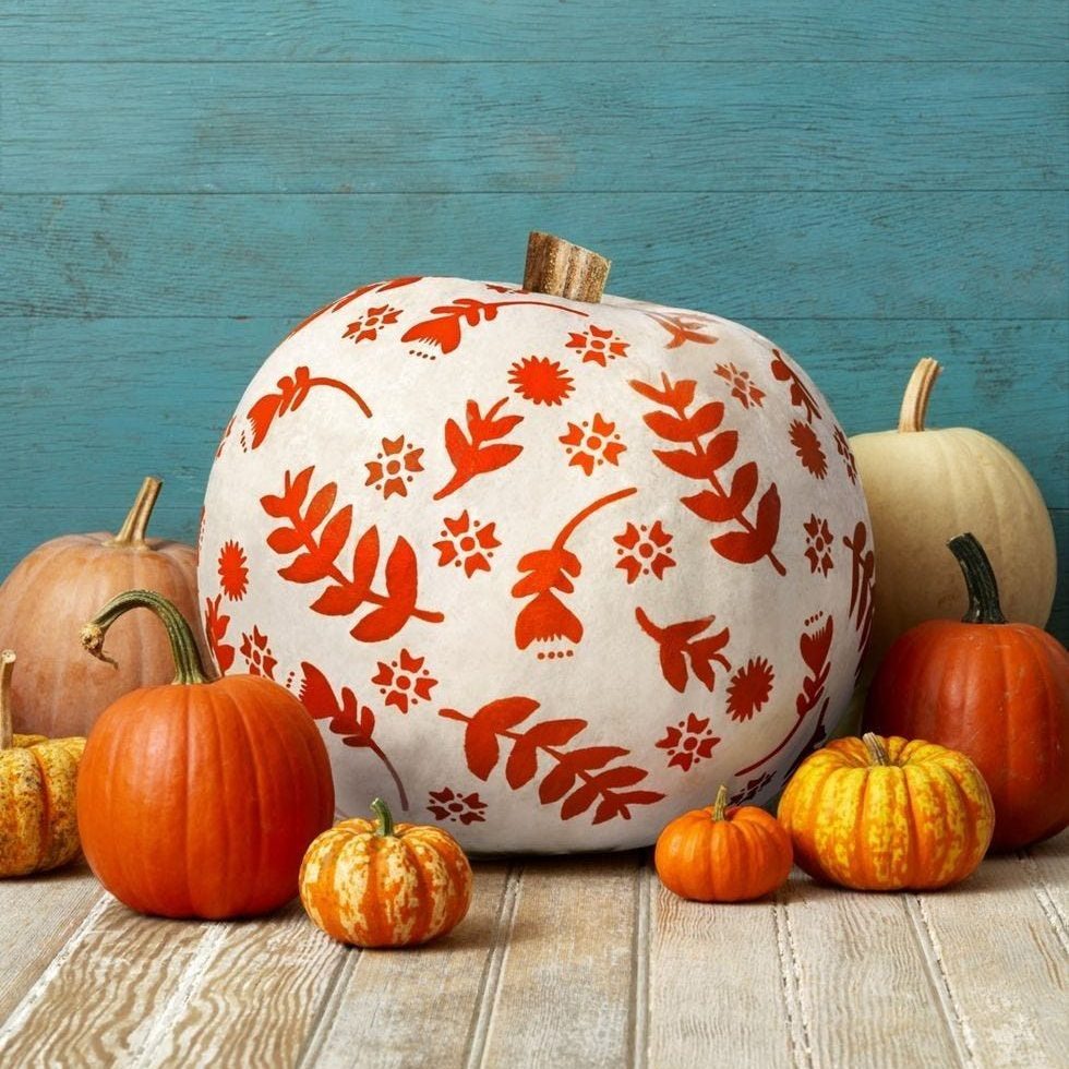 Painted white pumpkin with red folk designs