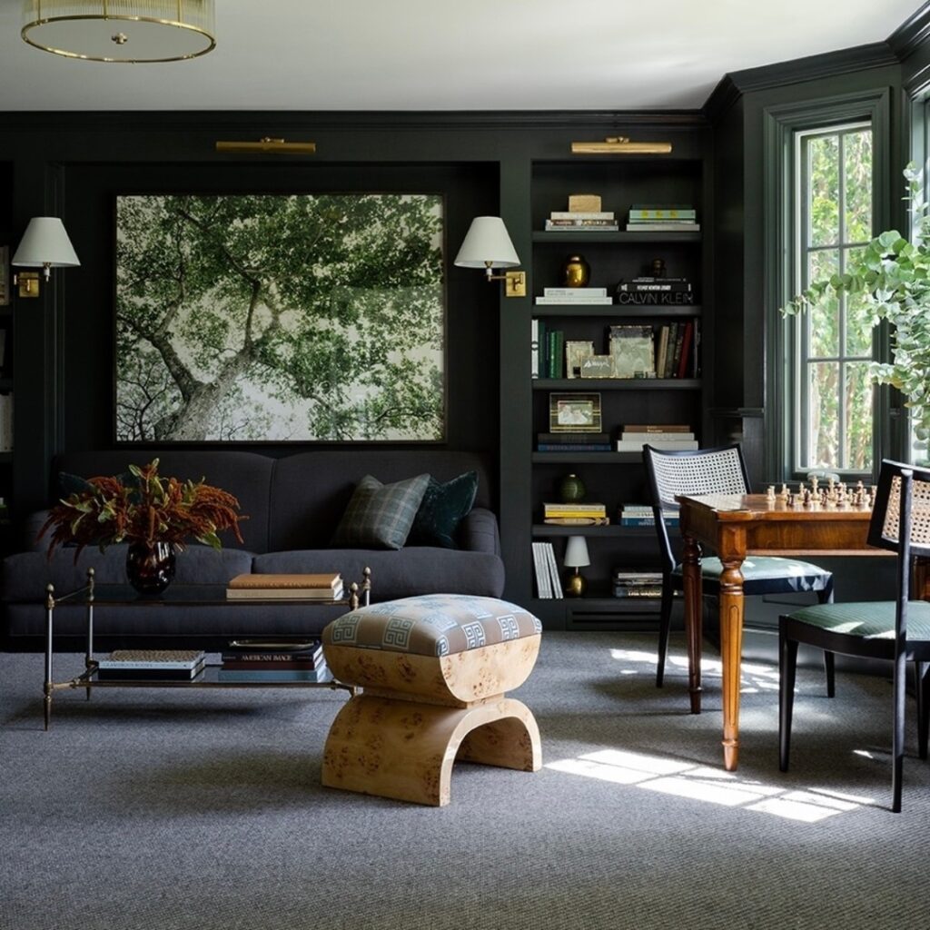 Dark green living room with tree photograph and bookshelves