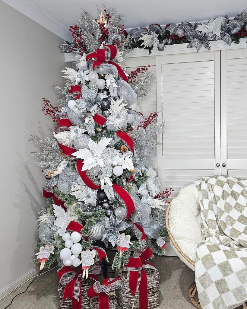 Christmas tree with silver and red decorations, angel ornaments.