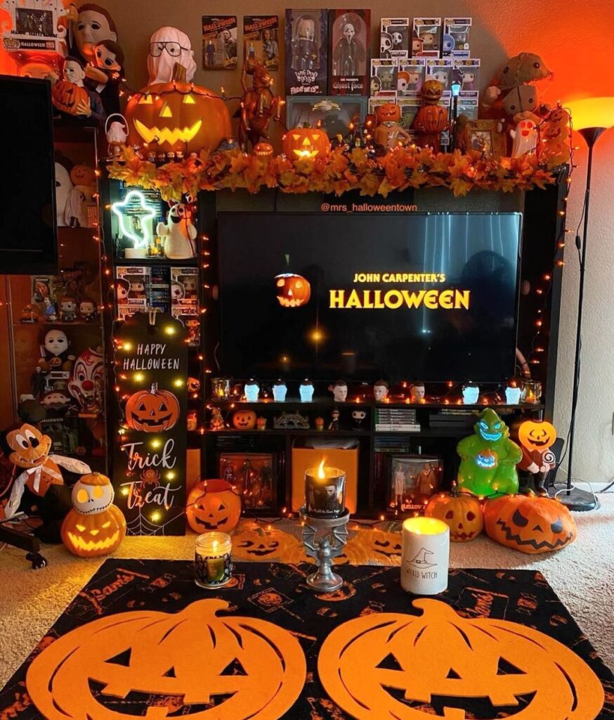 Halloween-themed entertainment center with horror movie collectibles and decorations