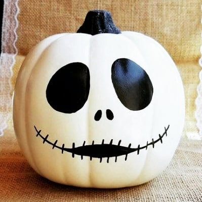 White pumpkin painted as Jack Skellington face