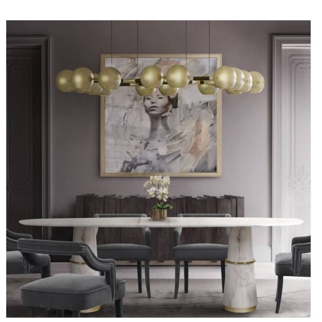 Elegant marble dining table with gray chairs and brass globe lights