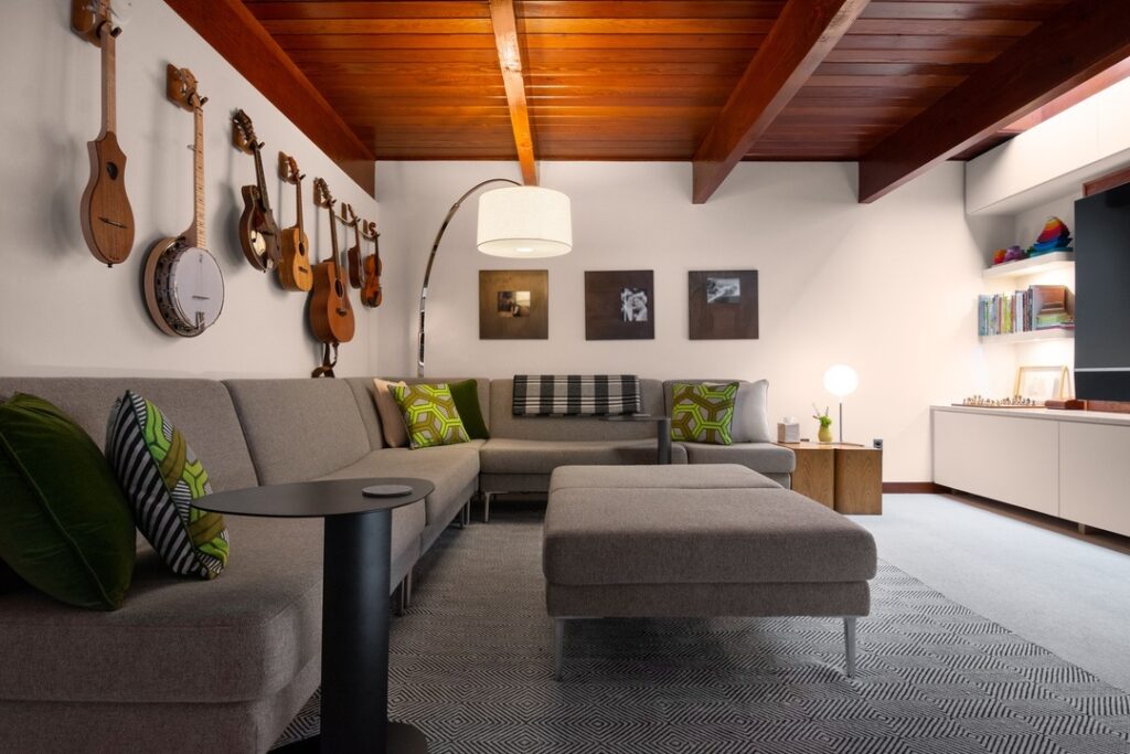 Modern living room with wooden ceiling and musical instruments on wall