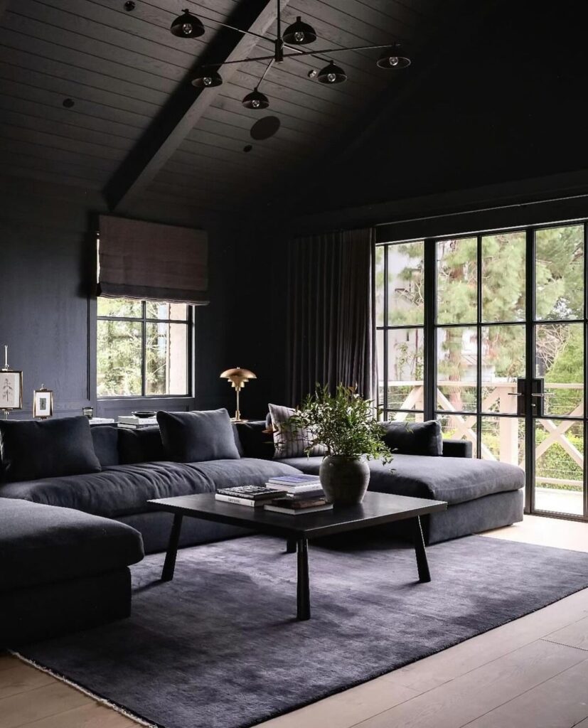 Dark living room with forest view and modern decor