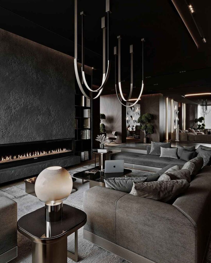 Moody black living room with fireplace, curved sofas, and unique lighting.