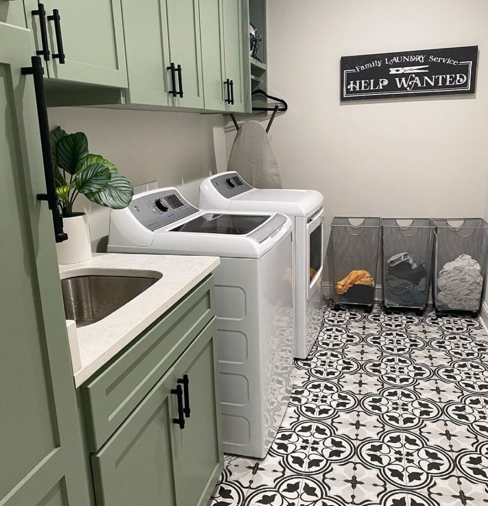 Modern laundry room with mint cabinets and patterned floor tiles.