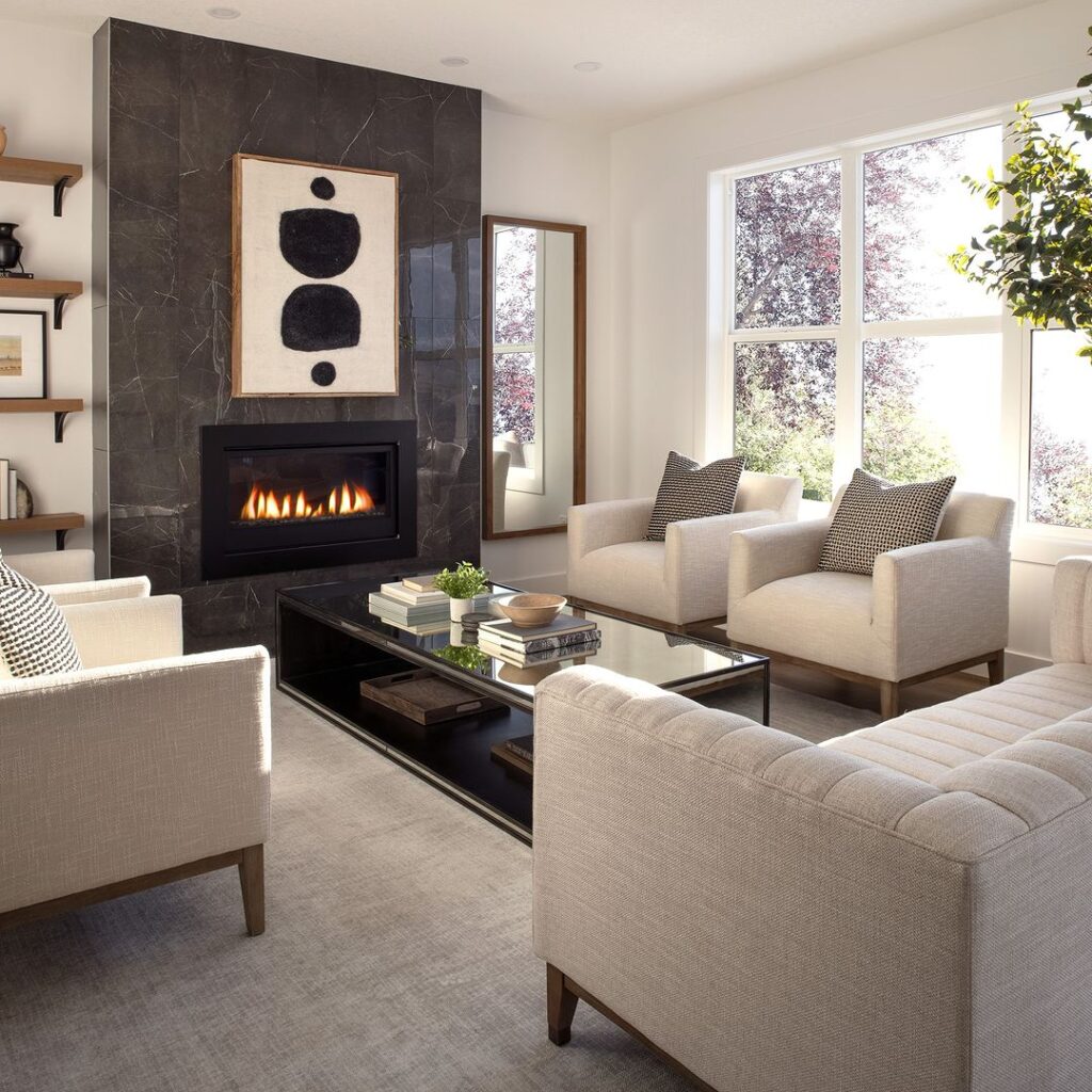 Stylish living room with marble fireplace, abstract art, and light furniture.