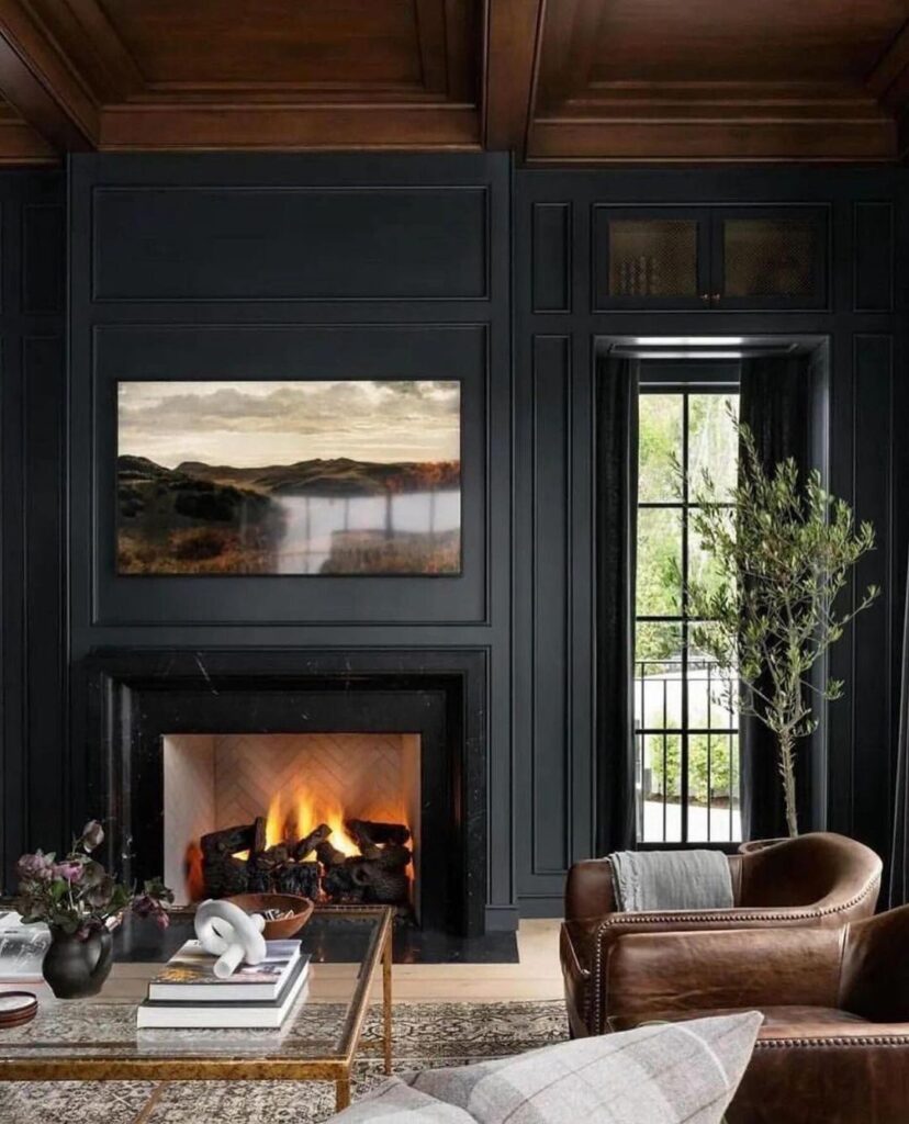 Dark living room with fireplace artwork and leather chair.