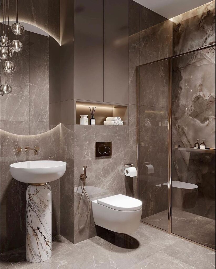 Modern bathroom with dark marble walls sculptural sink and mood lighting