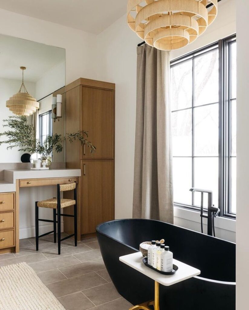 Bright bathroom with black tub and wooden vanity