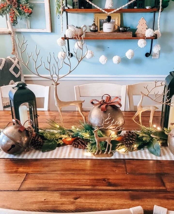 "Scandinavian Christmas table centerpiece with metallic deer and bells"