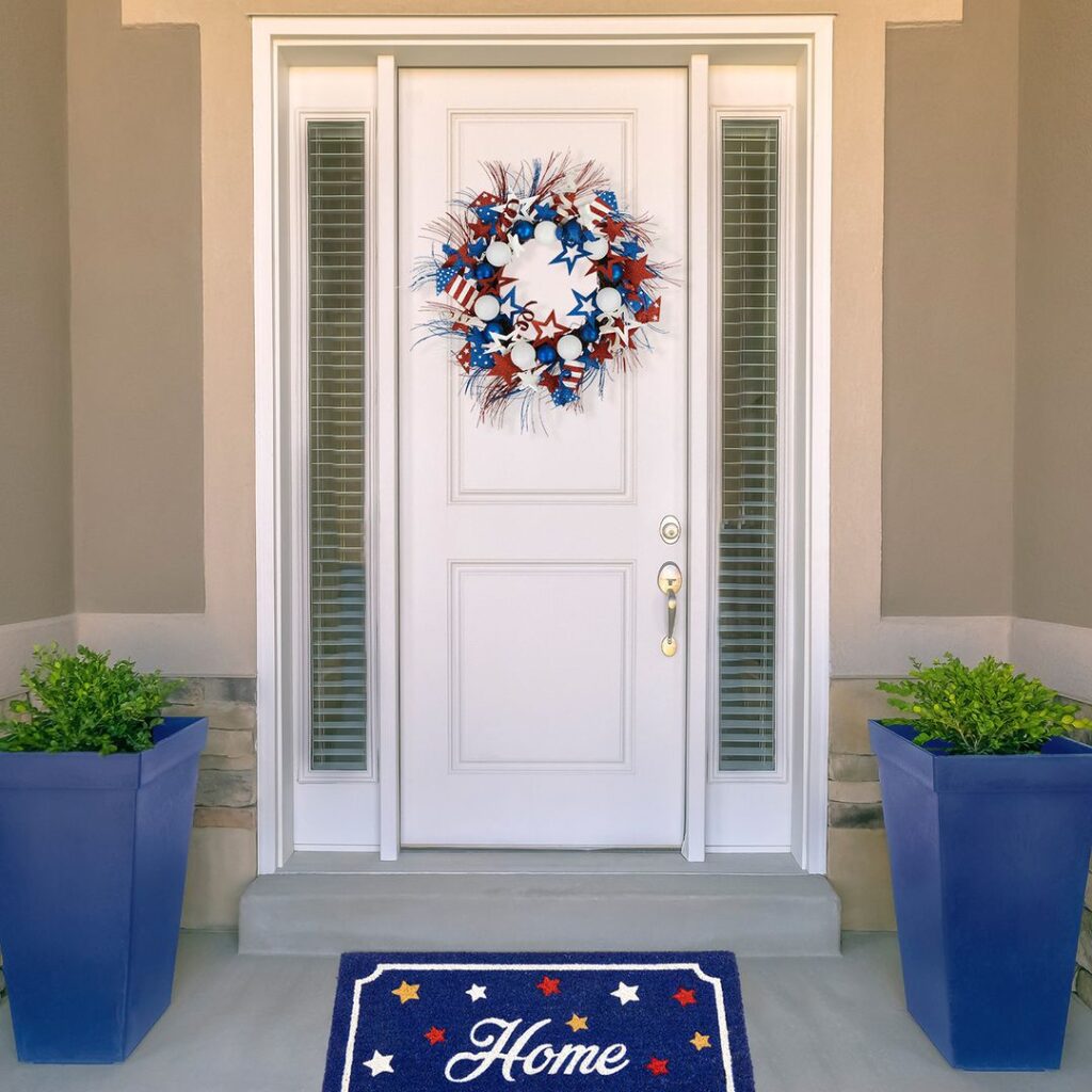 White door with patriotic wreath and blue planters