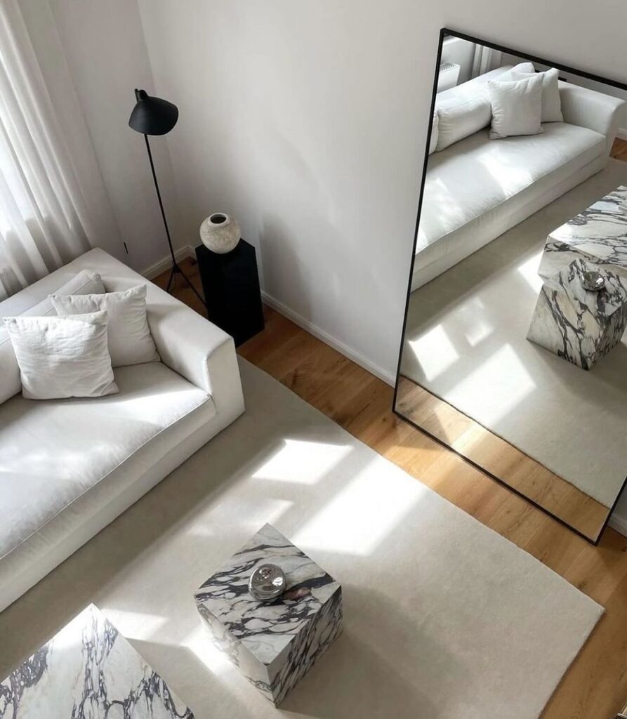 Minimalist white living room with large mirror