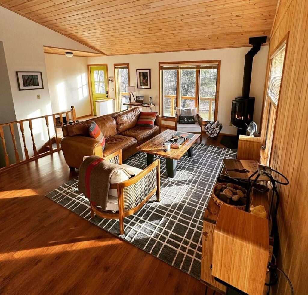 Cozy bohemian living room with wood ceiling and leather sofa.